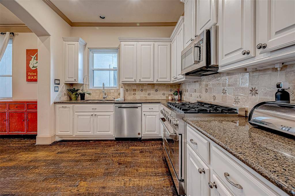 The kitchen offers plenty of space, making it perfect for cooking, storage, and entertaining.