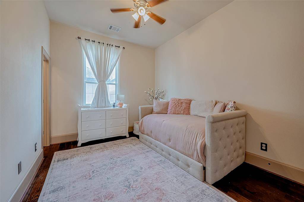 This upstairs secondary bedroom features its own private ensuite bathroom, offering comfort and privacy.