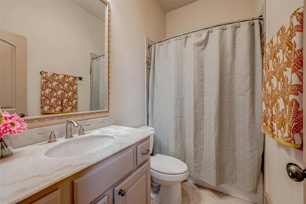 The secondary ensuite bathroom includes a private tub/shower combo with upgraded premium tile