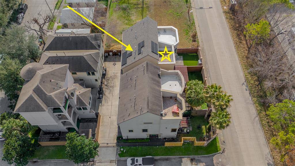 Aerial shows rooftop and solar panels