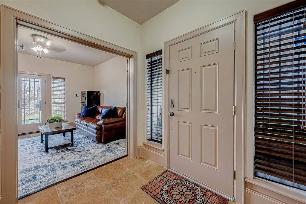 A welcoming entryway leads to a light-filled first-floor bedroom and ensuite