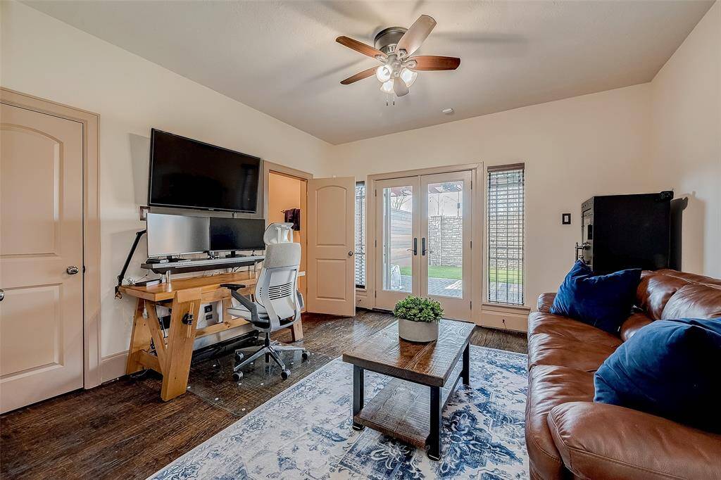 Featuring warm wood flooring, French doors that open to a backyard view, making it perfect for a home office or bedroom.