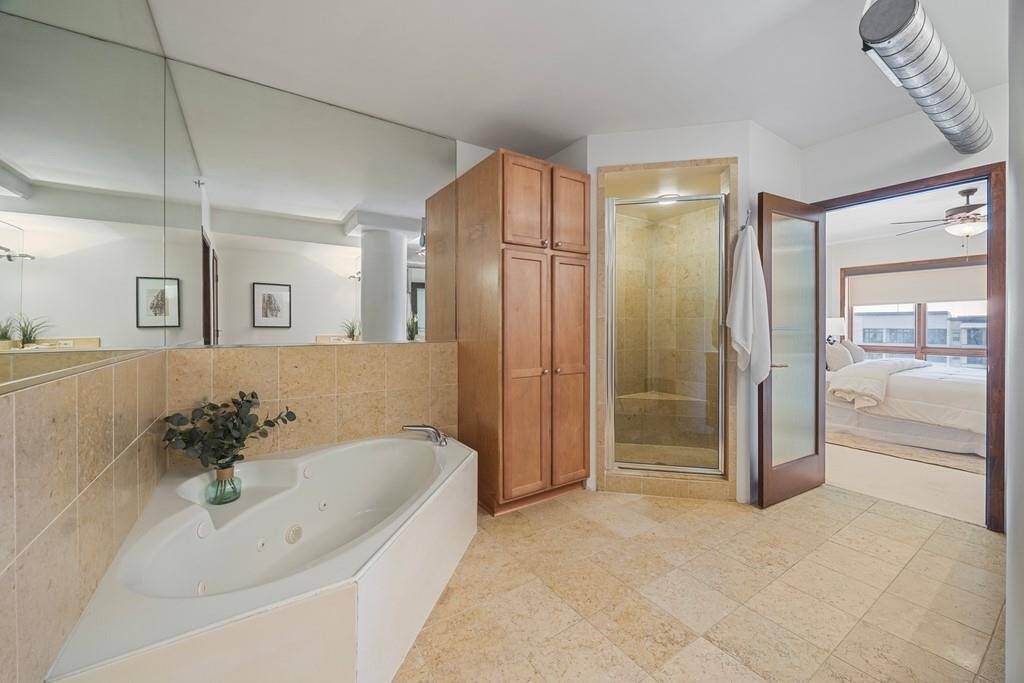 Primary ensuite bathroom with separate tub and shower