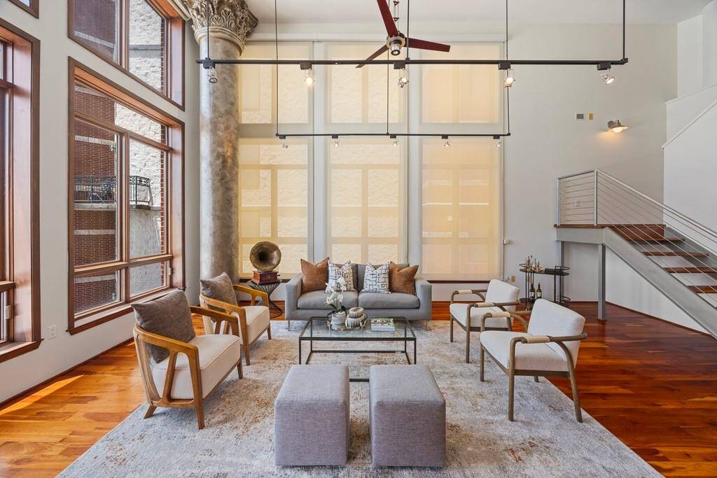 Gleaming hardwood floors, high ceilings, dramatic windows, electric custom shades.