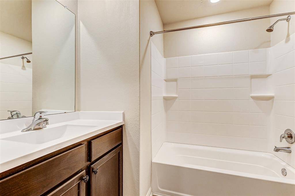 Secondary bathroom with fully tiled surrounding walls.