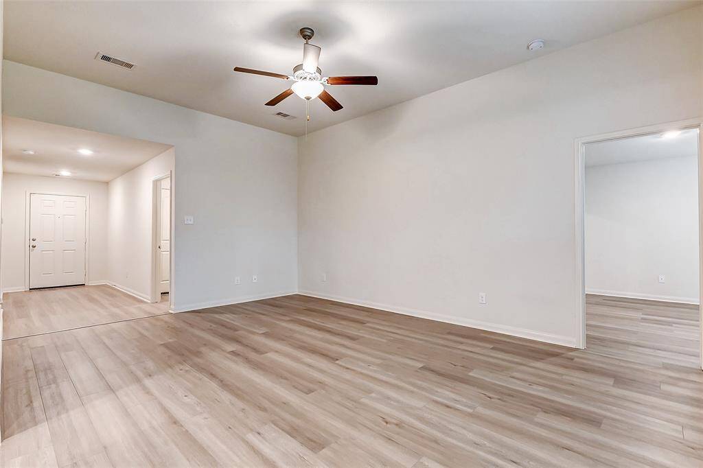 Front door leads into open entryway and family room with beautiful floors throughout the home.
