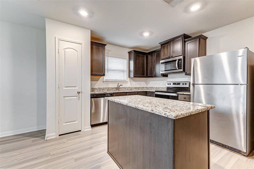 Chef's kitchen with large island, refrigerator included.