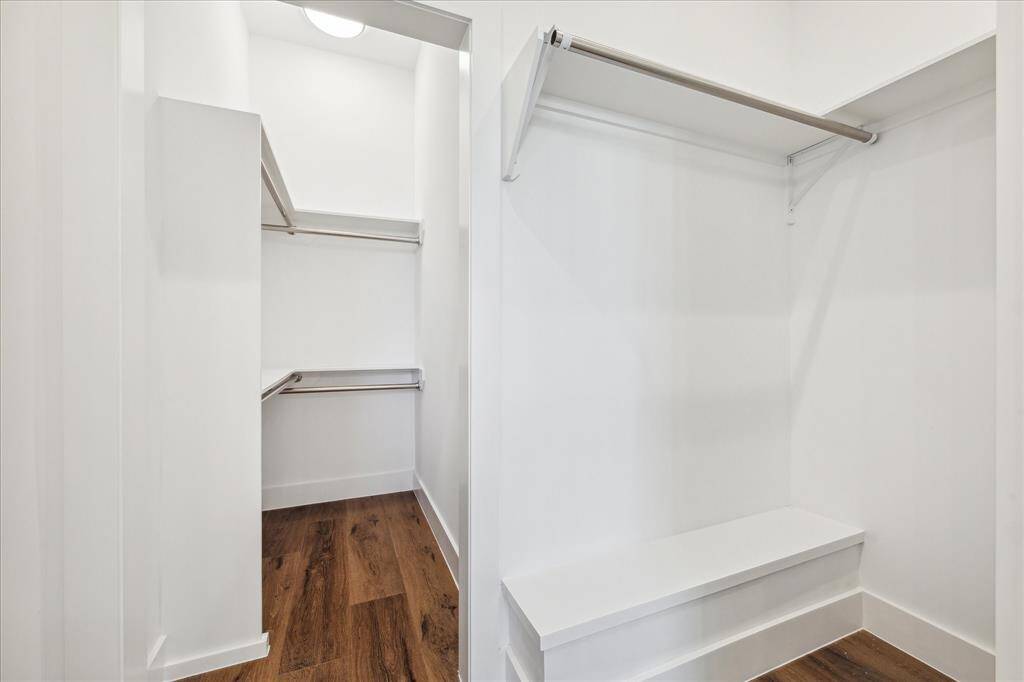The walk-in closet offers ample hanging space, built-in bench seating, and thoughtful storage potential—ready to keep everything organized and accessible.