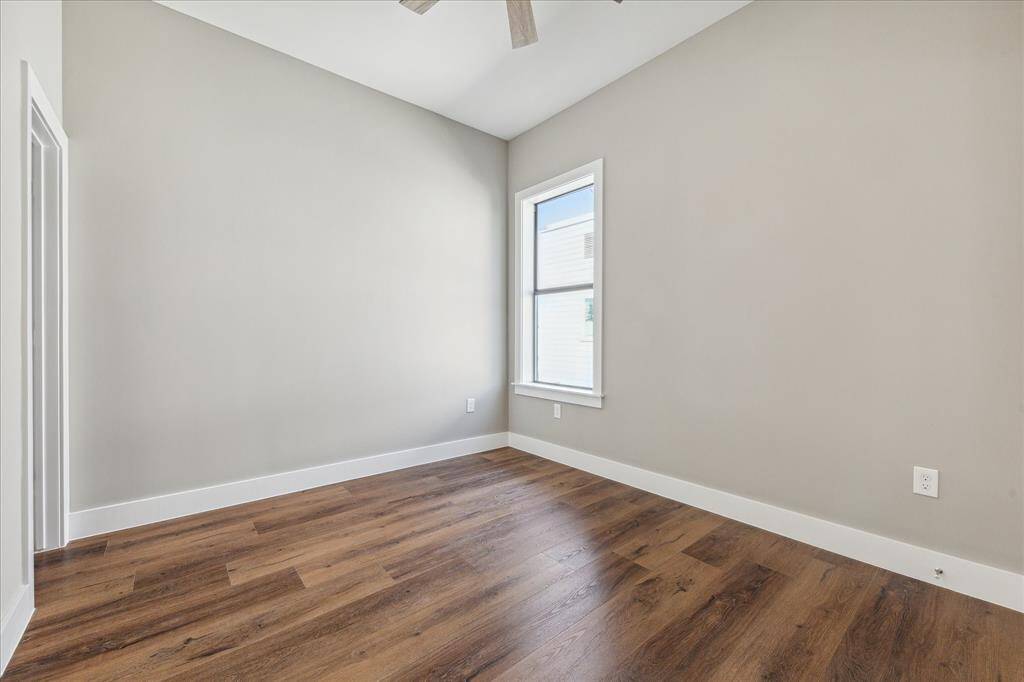 Located on the third floor, this secondary bedroom features luxury vinyl flooring, a neutral palette, and great natural light—perfect for flexible everyday use.