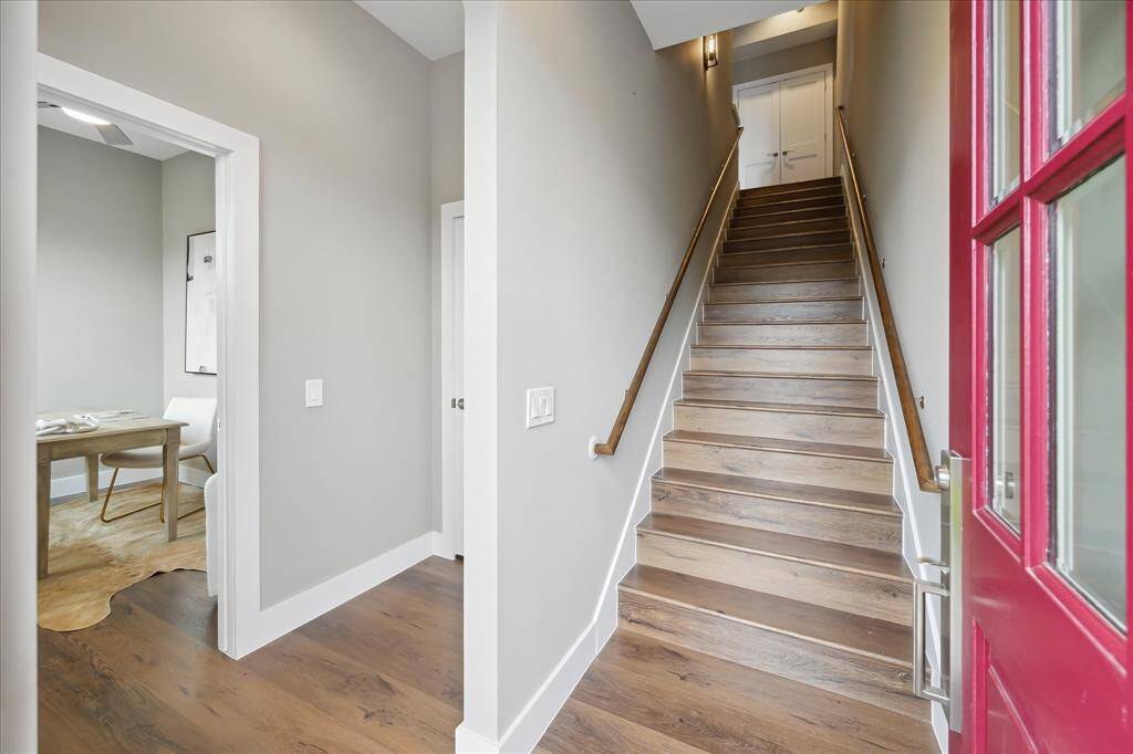 Step through the eye-catching red door into a bright, contemporary entry with wide-plank luxury vinyl floors and clean, modern finishes. A fresh and stylish welcome that sets the tone for what’s ahead.