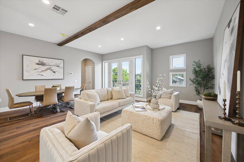 Soaked in natural light, this airy second-floor living area features elevated ceilings, wide-plank flooring, and oversized windows that frame Downtown views—perfect for relaxing or entertaining in style.
