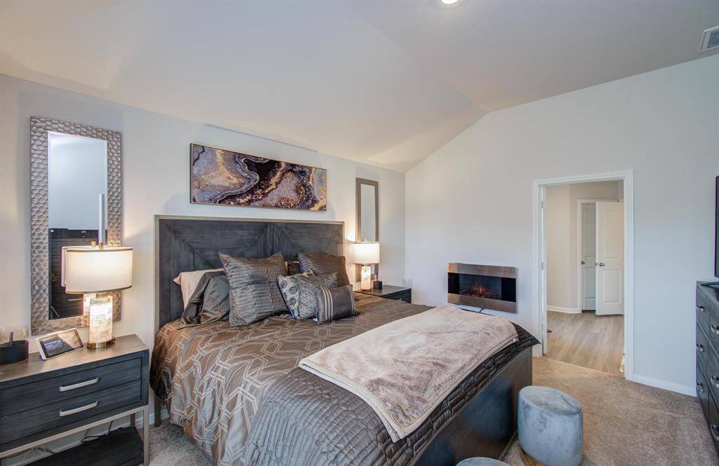 Luxurious primary suite features serene ambiance for ultimate relaxation.