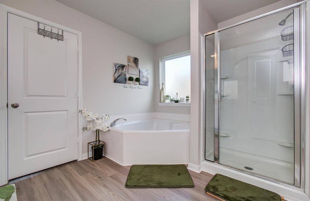 Indulge in luxury with a primary en suite featuring a garden tub and separate shower.