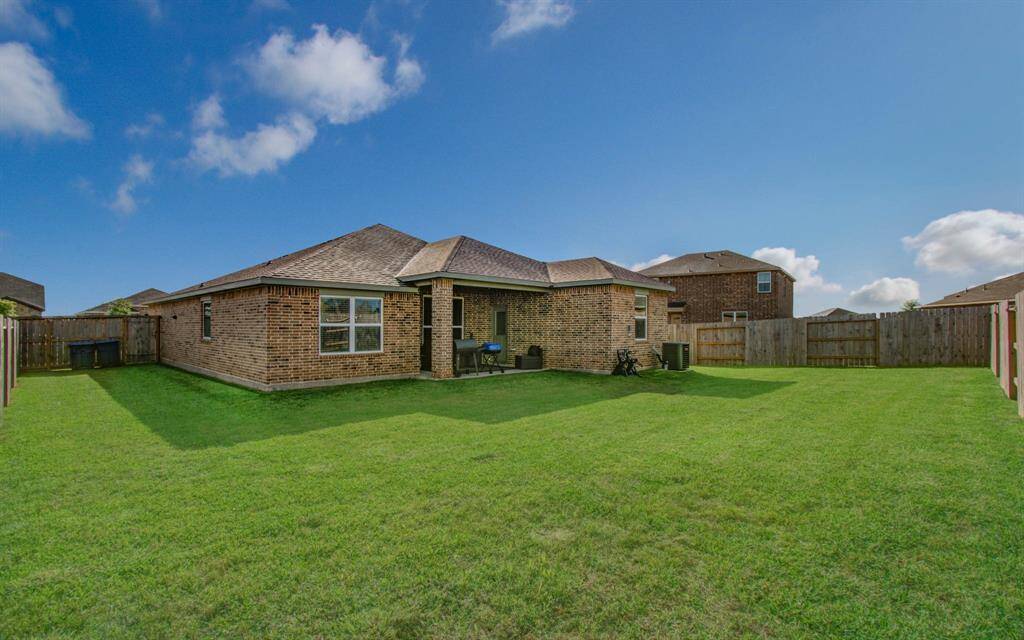 Relax on the spacious covered patio, perfect for enjoying the backyard -- including moring sunrises and beautiful evening sunsets.