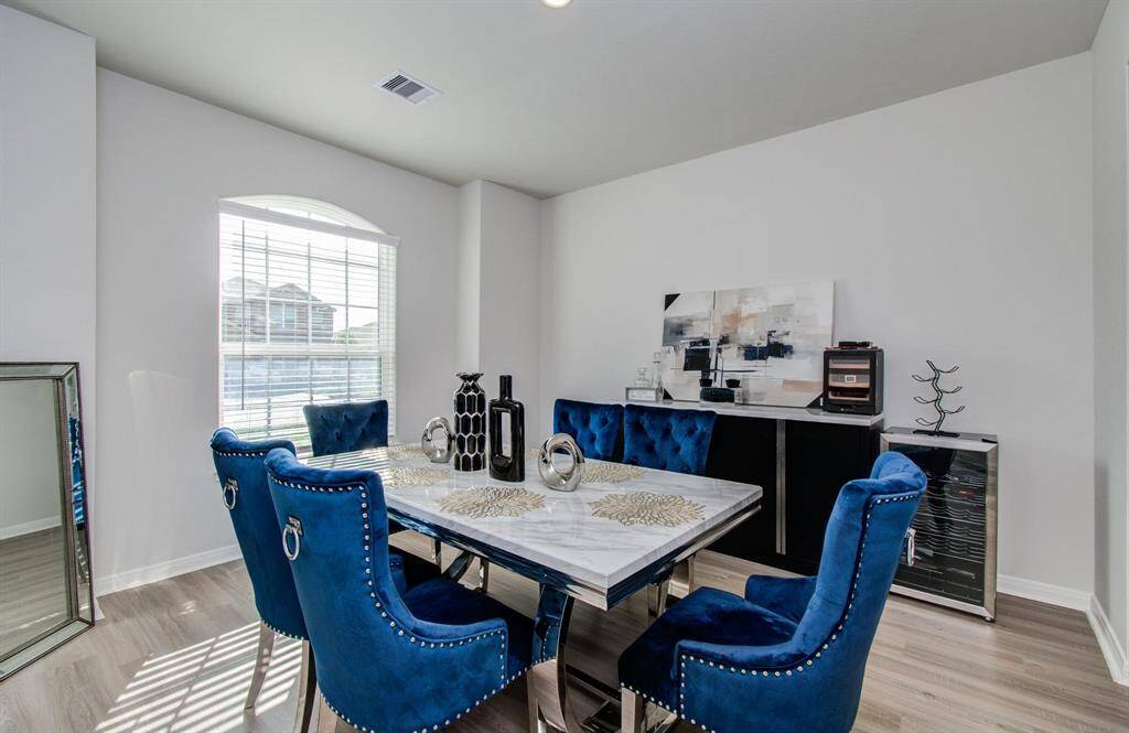 Experience the inviting charm of the bright and airy dining room, perfectly positioned at the front of the home off the foyer.