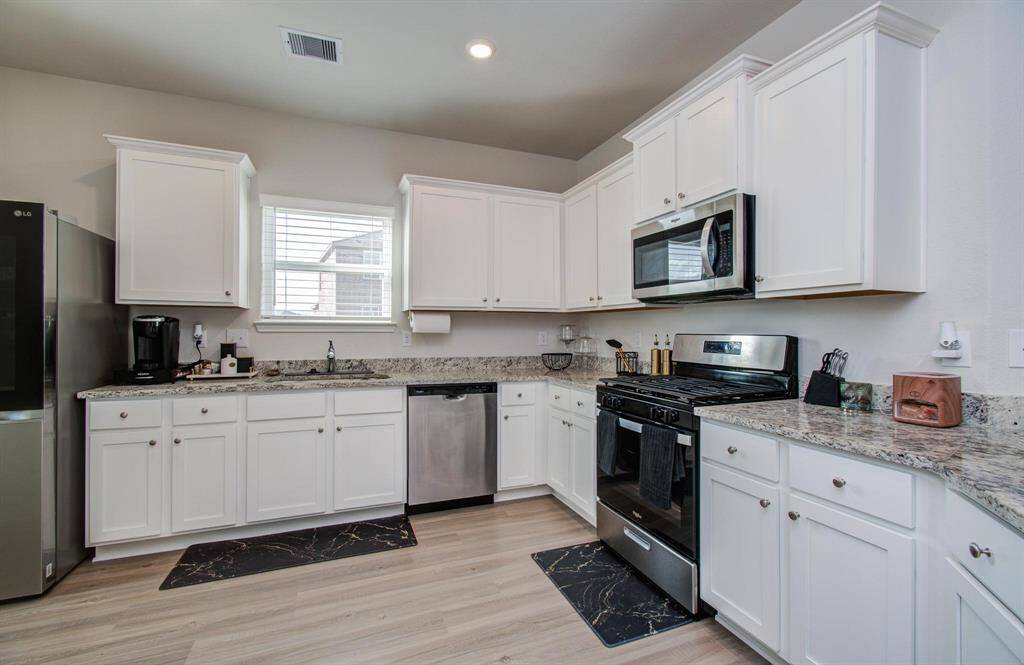 Flooded with natural light, the window above the sink brightens the kitchen beautifully.