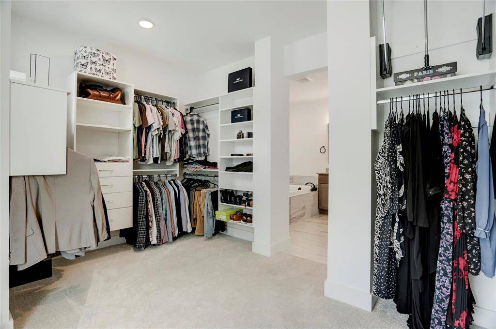 Another angle of the primary closet looking toward the bathroom.