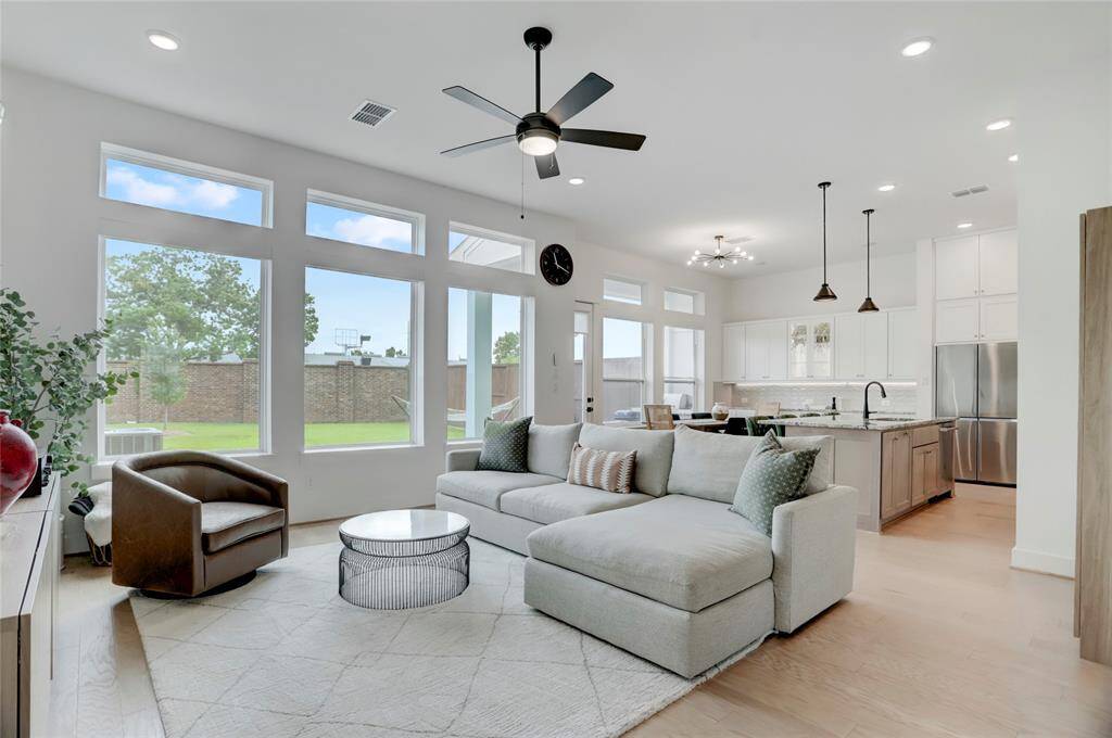 The wide-open first-floor living offers abundant natural light, 11' ceilings, all overlooking the spacious and rare backyard in the community.