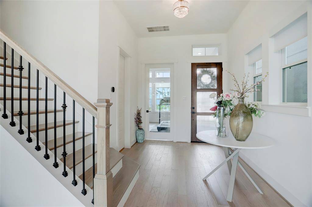 The entry foyer offers some buffer as you walk in the home. The glass door leads you into the study.