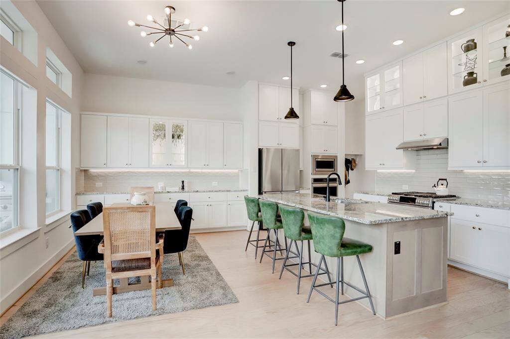 View of the dining and kitchen areas from the living room. Notice the ample storage and counter space in both rooms.