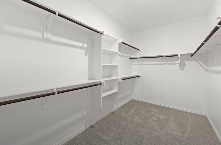 A stylish walk-in closet awaits, providing ample storage for your wardrobe and a little extra room for those cherished items.