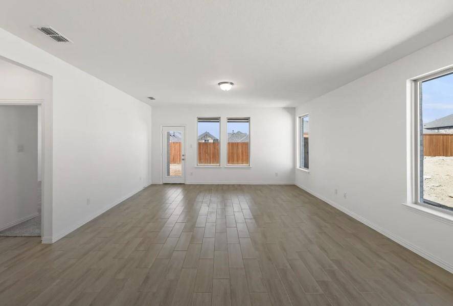 Picture expansive windows that invite natural light to dance through spacious living areas, creating a welcoming atmosphere perfect for gatherings or quiet moments of reflection.