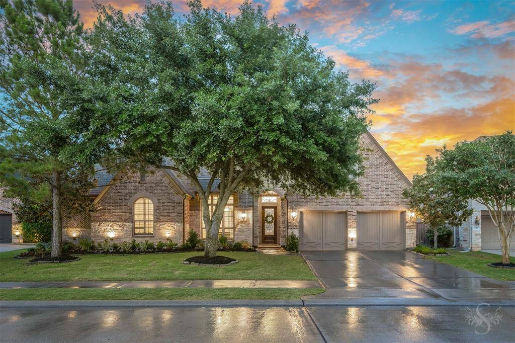 Welcome to 3311 Reston Landing Lane. Situated in the highly desired Cinco Ranch Northwest, this beautiful brick and stone one story home features a charming exterior with a manicured lawn, mature trees, and a three-car tandem garage.