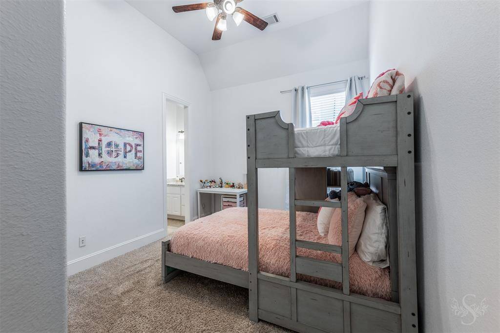 This is the second of three secondary bedrooms. This bedroom is connected to another secondary bedroom with a Hollywood bath.