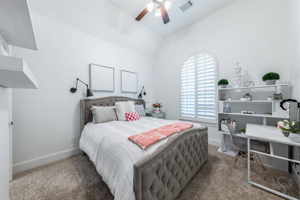 The third secondary bedroom features an arched window with shutters. All bedrooms include spacious closets.