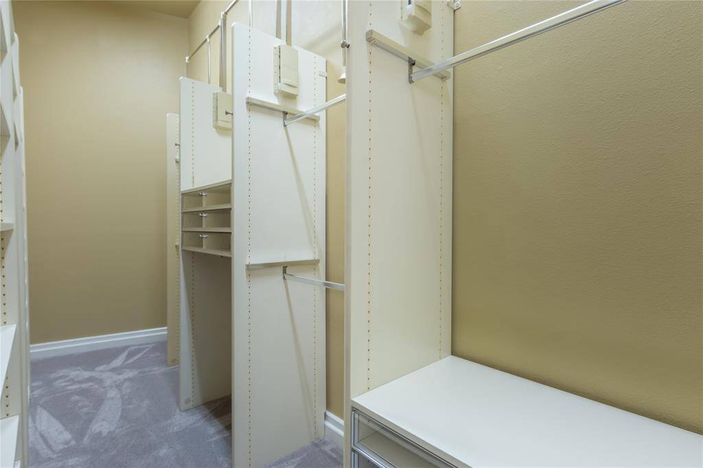 Primary bedroom's closet is amazing with pull downs, drawers etc..