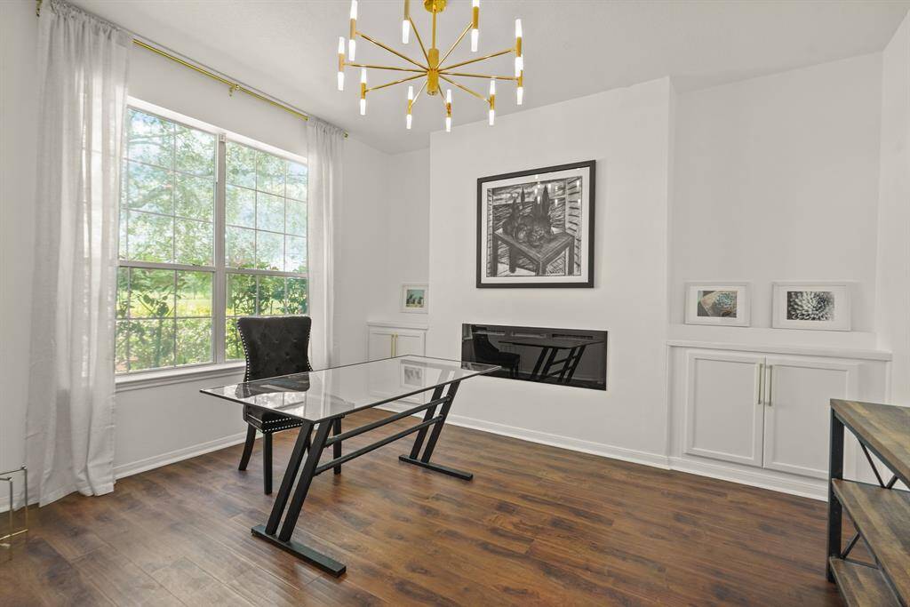 Charming downstairs office with an electric fireplace and stunning lake views.
