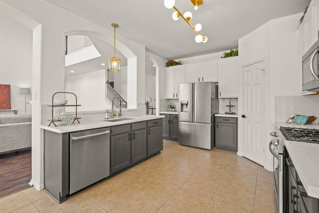 Sleek stainless steel appliances enhance the kitchen's modern appeal.