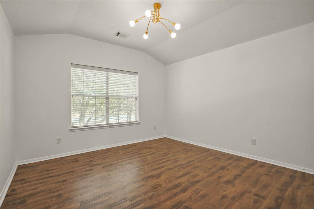 Spacious and inviting, Bedroom #3 features warm wood flooring and abundant natural light, perfect for relaxation or productivity.