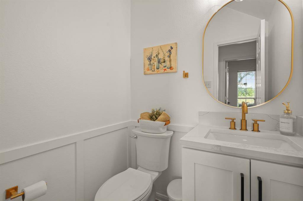 Convenient downstairs half bath with stylish fixtures.
