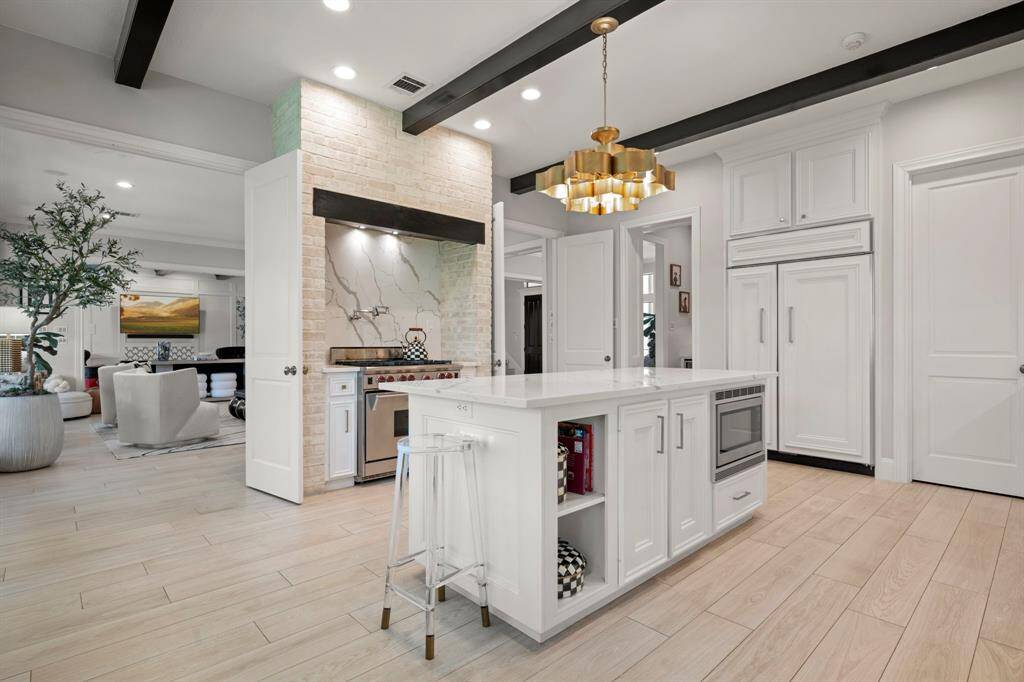 This kitchen has a great flow and a six burner Wolf stove complete with a pot filler