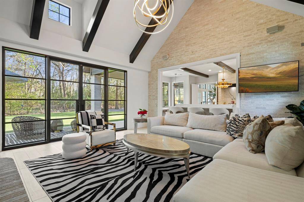 Holidays and entertaining become magical in this great room. Cathedral ceiling, fully white brick accent walls and wood burning fireplace create the most intimate setting