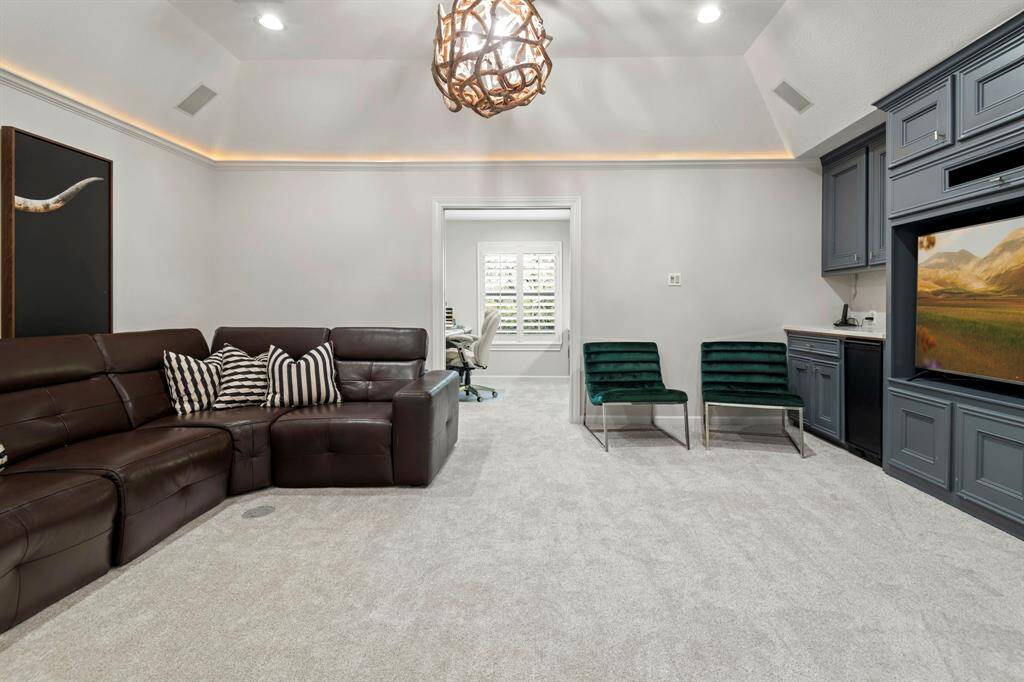 Media room with custom lighting, built ins and a workstation