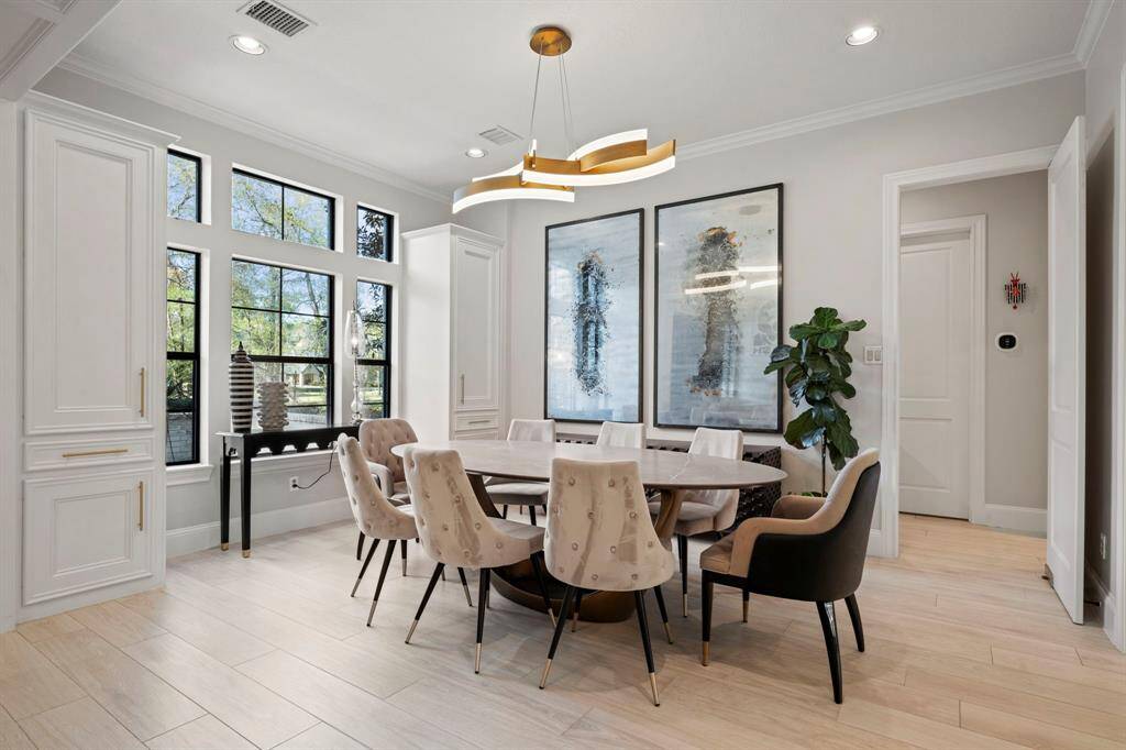 Formal dining room featuring builtins and designer lighting.