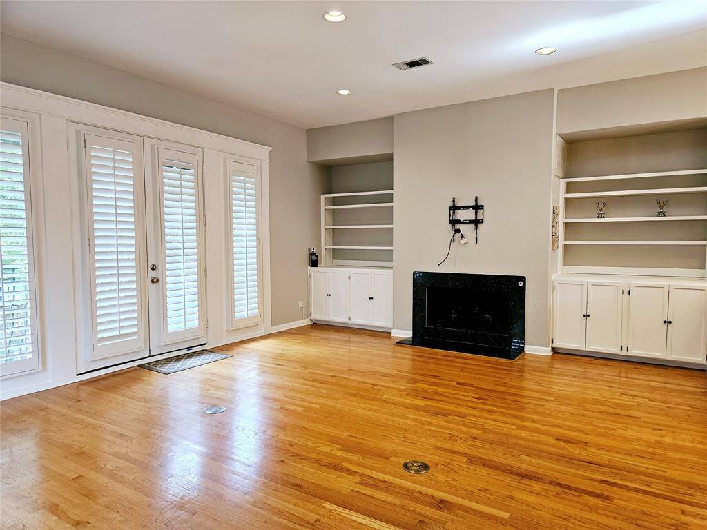 Open living with built in bookshelves & fireplace