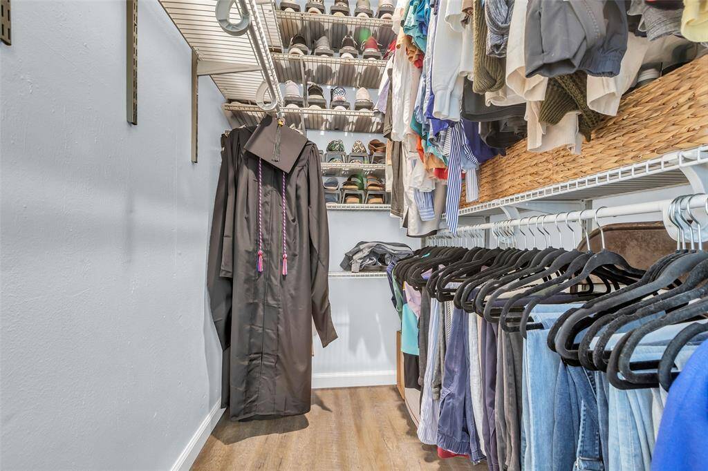 One of two spacious walk-in closets featuring custom shelving, dedicated shoe racks, and plenty of hanging space. A true bonus for organizing seasonal wardrobes or shared closet needs.