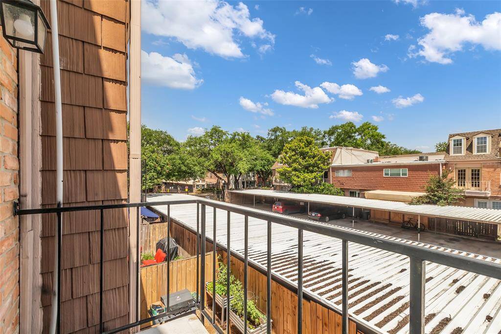 Private balcony overlooking the covered parking area and lush mature trees. Enjoy peaceful morning coffee or evening sunsets with open sky views and a serene residential setting.