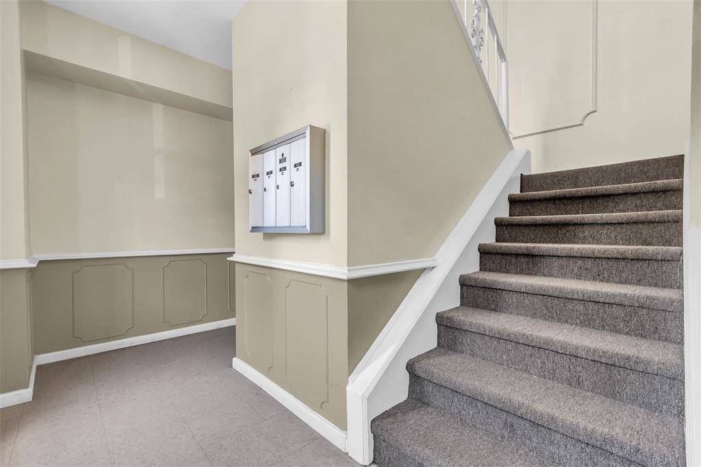 Neat and well-kept shared entry with secured mailboxes and a clean, welcoming ambiance. Neutral colors and paneled wall accents create a timeless, classic impression as you enter the building.