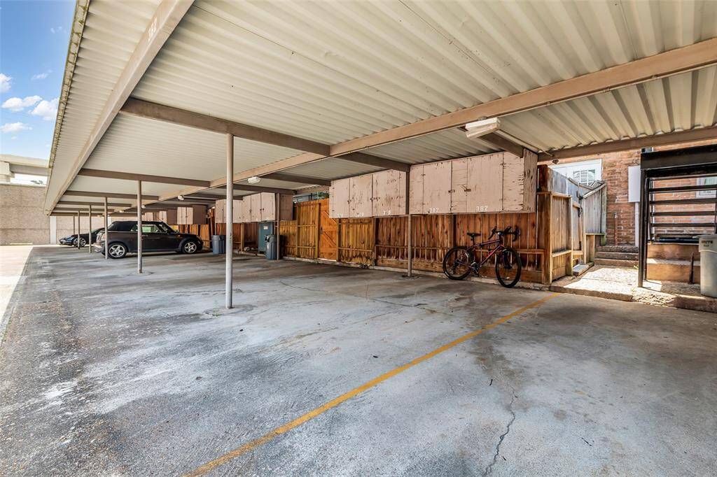 Two assigned, covered parking spaces located just outside the rear stairs. Includes secure wall-mounted storage units, offering added convenience for tools, bikes, or seasonal items.