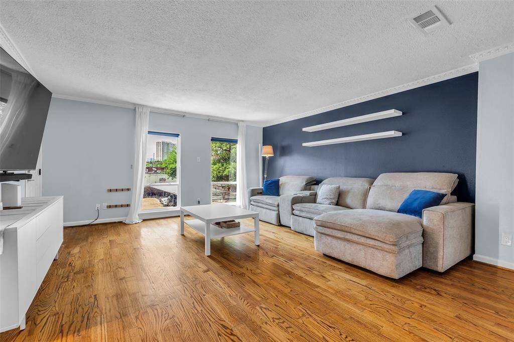 Enjoy natural light through large picture windows overlooking the tree-lined street and community.