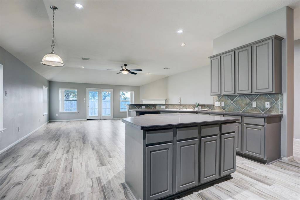 The large granite island with lots of cabinets for additional storage...
