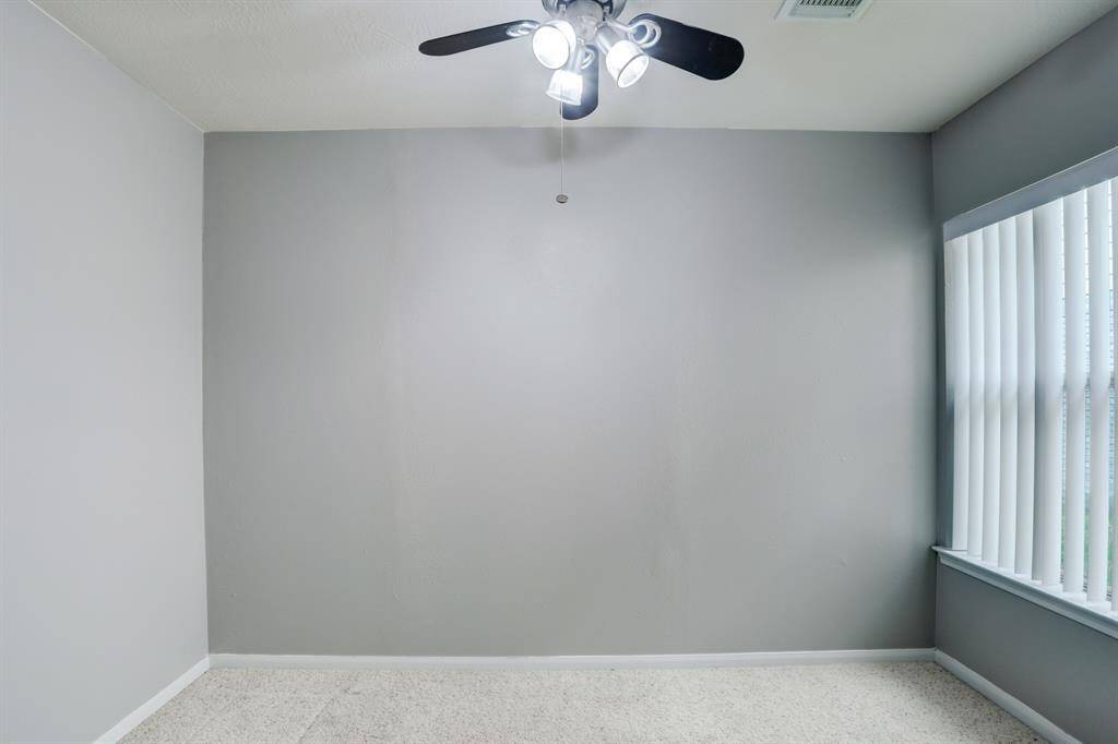 This versatile room with new carpet is located off the kitchen and is perfect for a home office or a study area.
