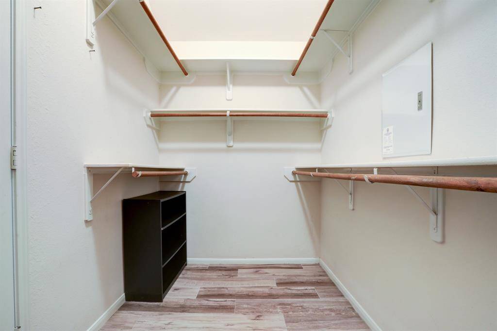 Spacious walk-in closet with ample shelving and storage options for organized living.