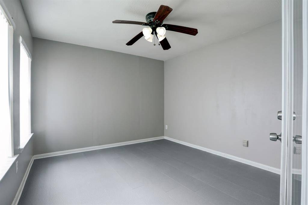 Explore this versatile room off the garage, ideal for an office, gym, or craft area. Features fresh paint, new flooring, central heat and air and a ceiling fan for added comfort.