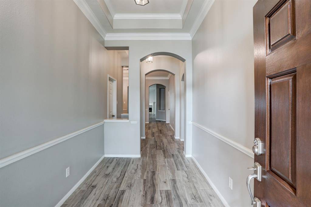 Elegant entryway featuring a sophisticated tray ceiling, setting a refined tone for the home.