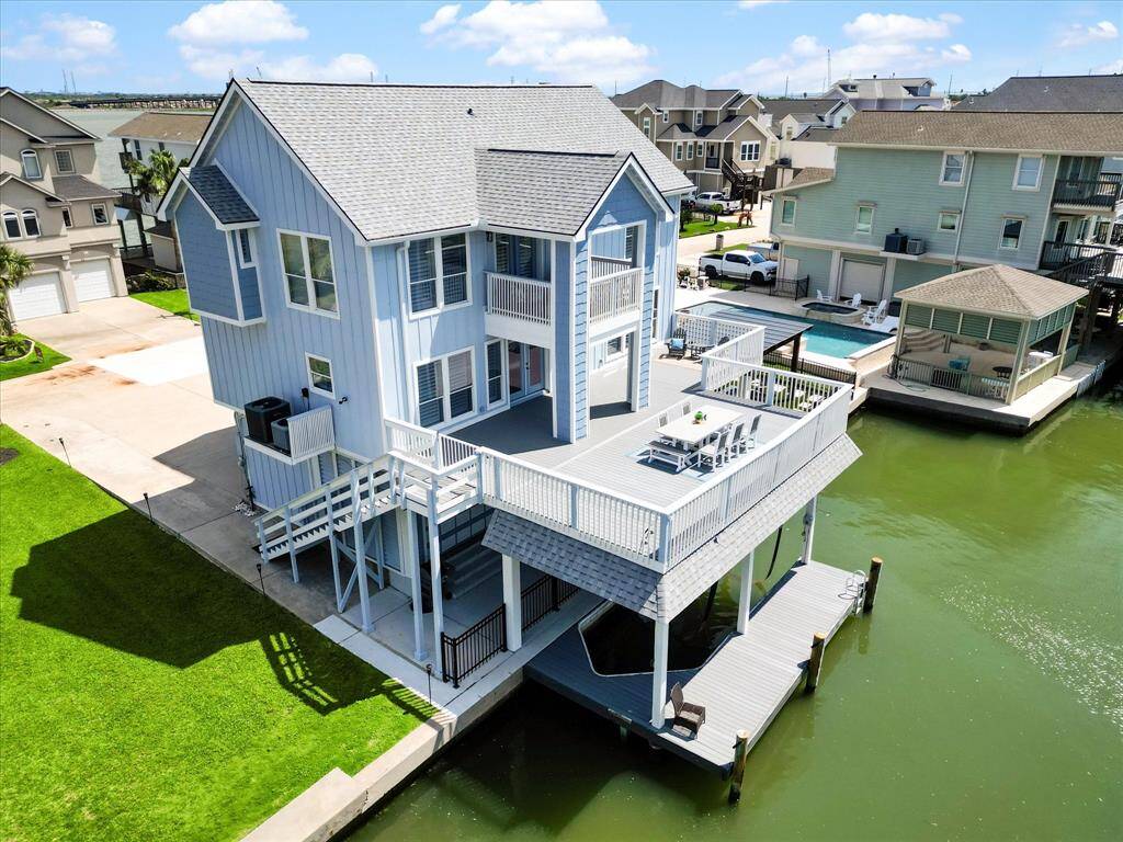 This waterfront home features a modern, multi-level design with a spacious deck overlooking the canal. It offers direct water access and picturesque views, perfect for those seeking a coastal lifestyle.